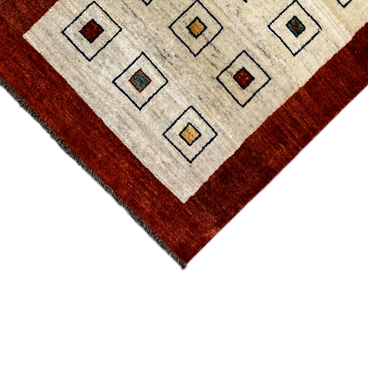 Runner rug corner: cream-colored pattern and reddish-brown border, short fringes