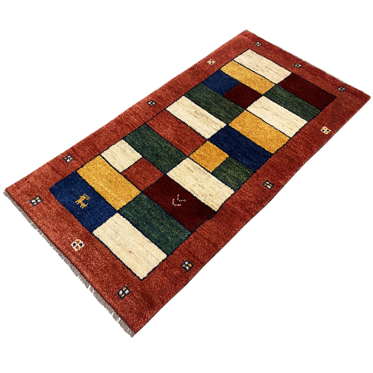 Gabbeh runner with patchwork rug sections in red, cream, blue, green, and yellow