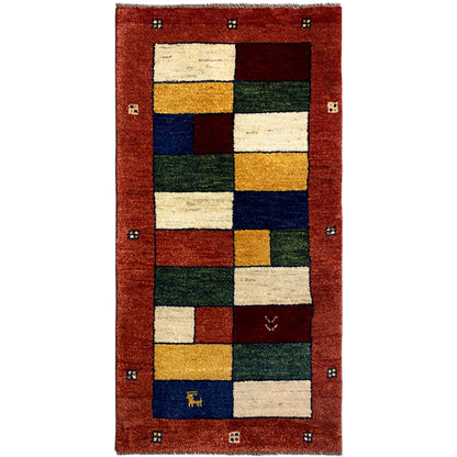 Gabbeh runner with a patchwork pattern in red, cream, blue, green, and gold