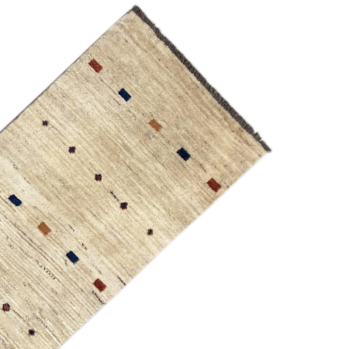 Gabbeh runner corner: light beige fabric with colored squares and dots, dark edging