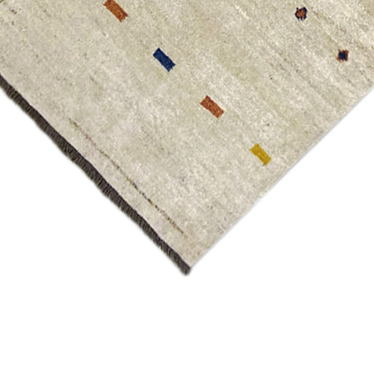 Close-up of Gabbeh runner hem: light beige with colorful squares, black border/fringe