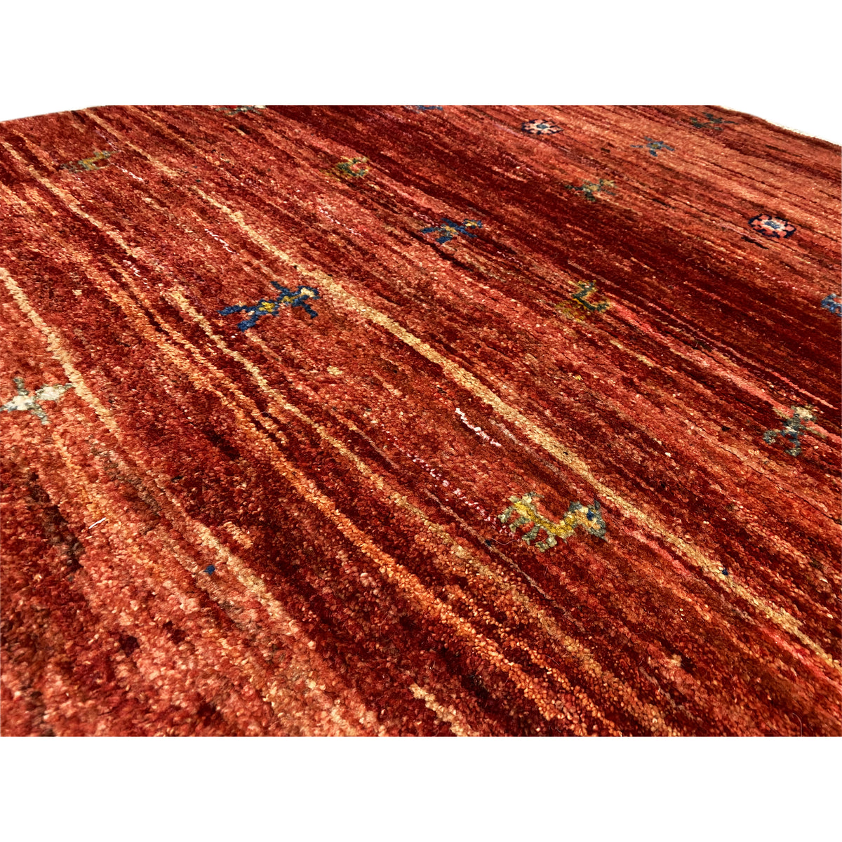Gabbeh rug 140x93 cm close-up: reddish-brown striped design with colorful motifs