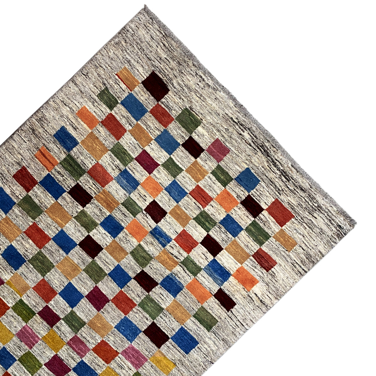 Gabbeh rug in angled view: beige background with multicolored rows of cubes