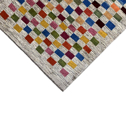 Gabbeh rug detail: geometric cube pattern on a light, mottled background