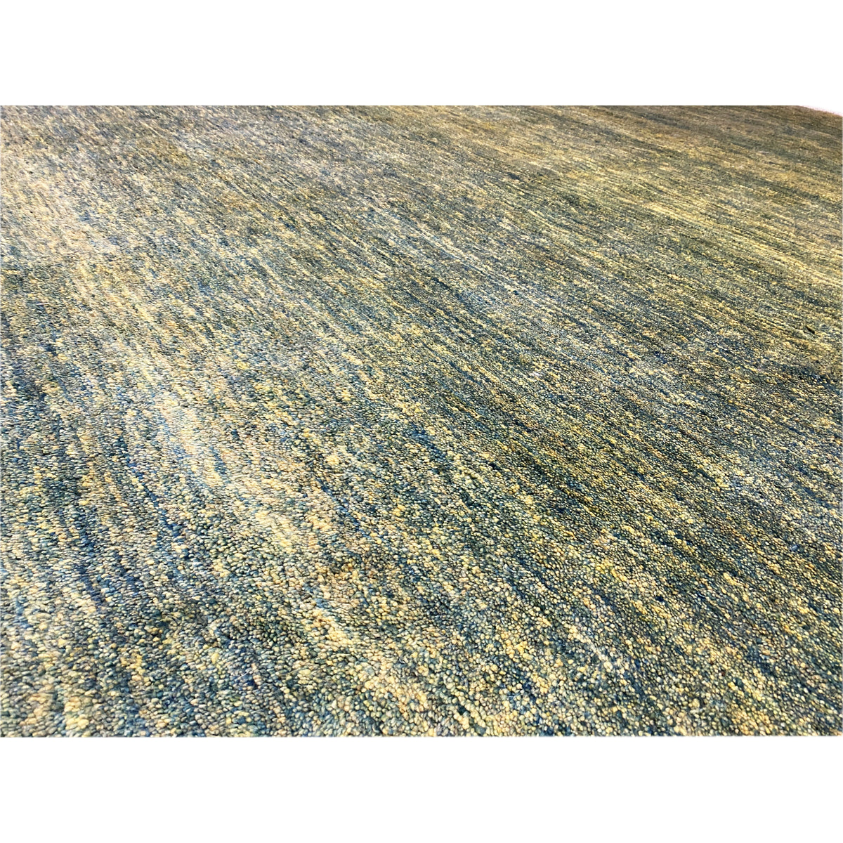 Close-up of Gabbeh rug: green-yellow mélange, fine woven fiber texture