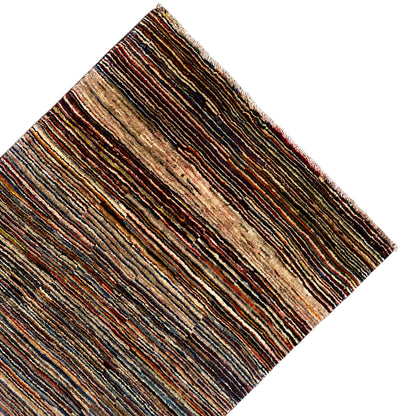 Gabbeh rug at an angle: brown, beige and blue color stripes