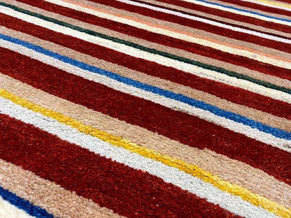 Rug with wide stripes in red, blue, beige, and yellow, fine woven texture