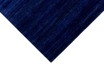 Blue Gabbeh rug, detail of a corner with an even woven texture