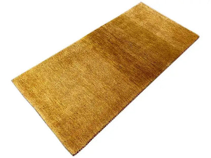 Gabbeh rug 131x62 cm, rectangular, mustard-gold pile with an even texture