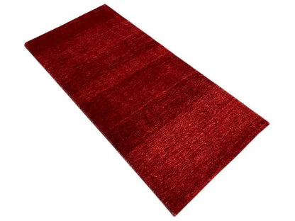 Diagonal rug, mottled burgundy red, narrow edges, flat-woven