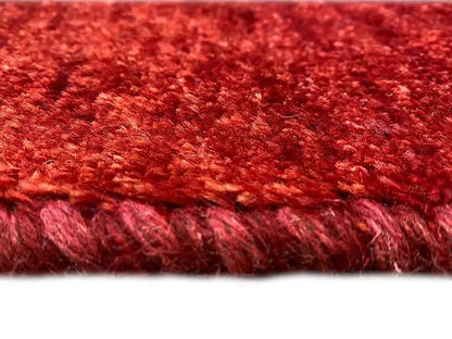 Carpet detail: red mottled pile surface with short, dense fibers