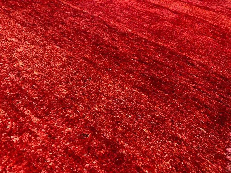 Carpet surface: mottled burgundy red, fine texture, dense pile