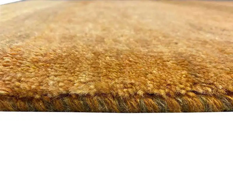 Gabbeh rug (151x100 cm) close-up: ochre-brown pile texture, dense fiber weave