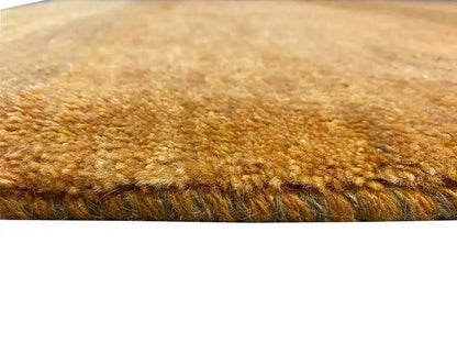 Gabbeh rug (151x100 cm) close-up: ochre-brown pile texture, dense fiber weave