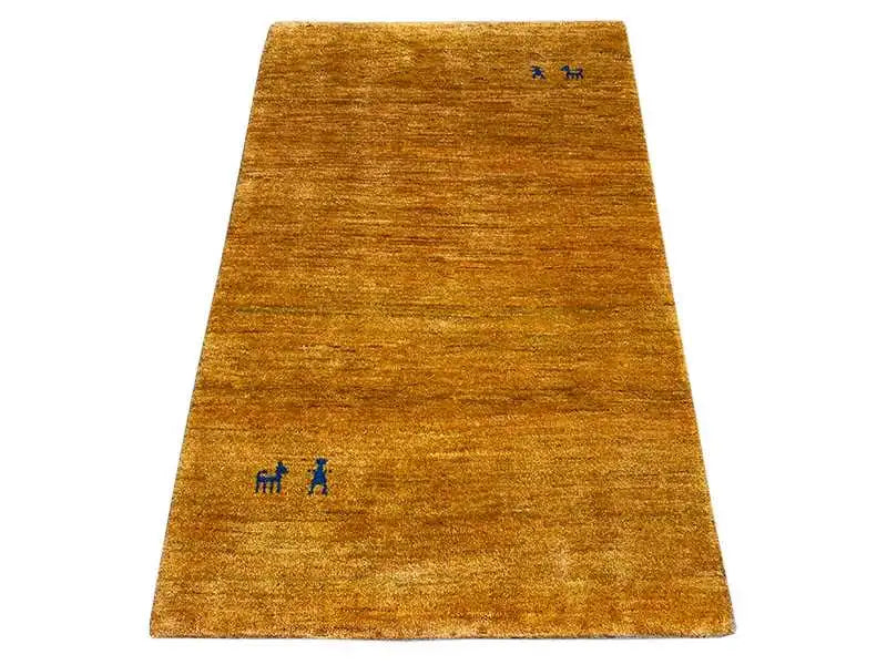 Gabbeh rug in golden brown, simple with small blue accents