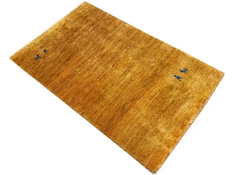 Gabbeh rug in honey gold with a subtle blue decorative motif