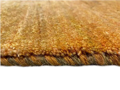 Gabbeh rug, golden-yellow surface with a dense pile and closed edge