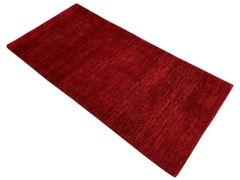 Red Gabbeh rug, 171x82 cm, laid flat, mottled pile surface