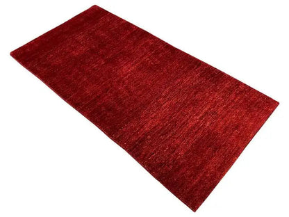 Red Gabbeh rug, 171x82 cm, laid flat, mottled surface
