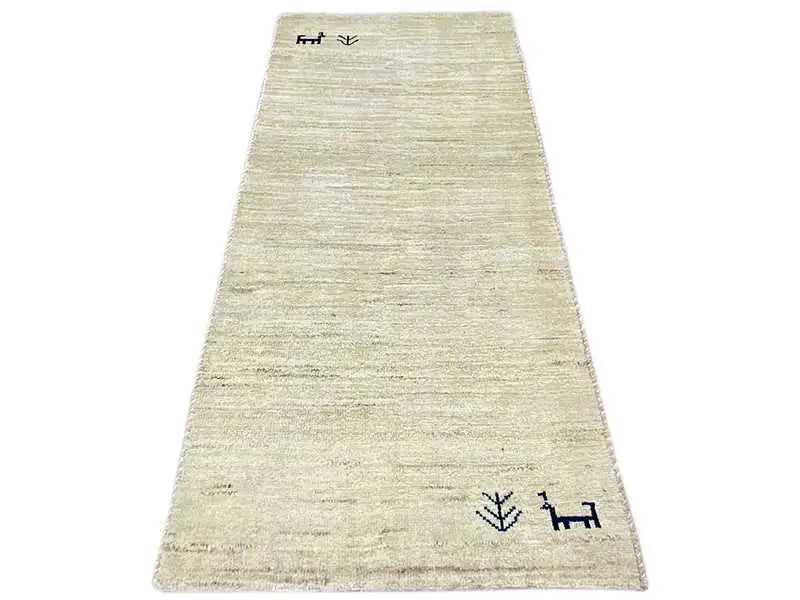 Gabbeh rug 135x65 cm, beige pile with dark borders and symbols.