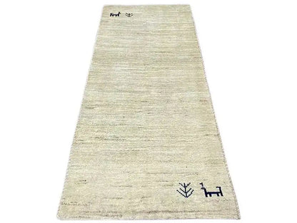 Gabbeh rug 135x65 cm, beige pile with dark borders and symbols.