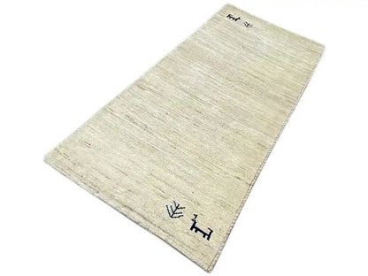 Gabbeh rug 135x65 cm, beige pile, dark blue symbols in two corners.