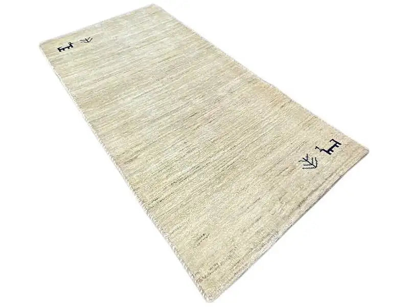 Gabbeh rug 135x65 cm, beige pile with a fine woven texture and dark corner symbols.