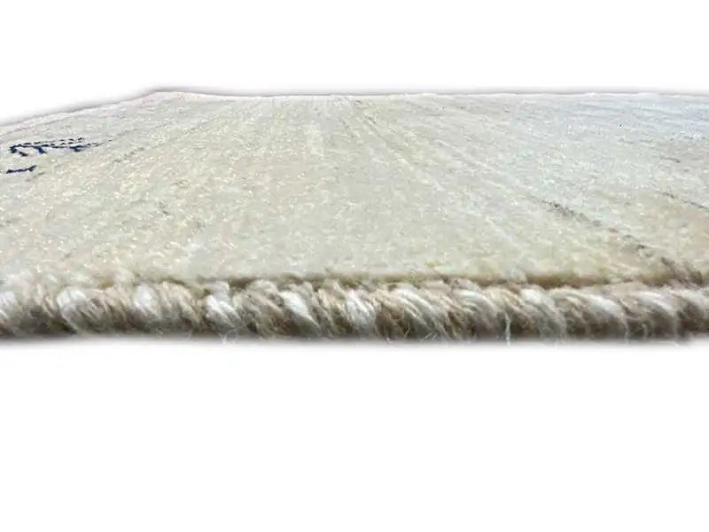 Gabbeh rug 135x65 cm, beige pile with a short fringe border.