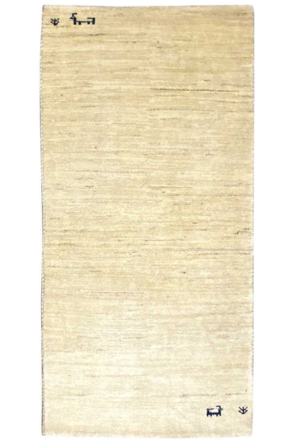 Rectangular Gabbeh rug in light beige, plain surface with small blue motifs