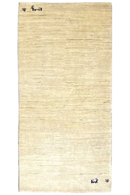 Rectangular Gabbeh rug in light beige, plain surface with small blue motifs
