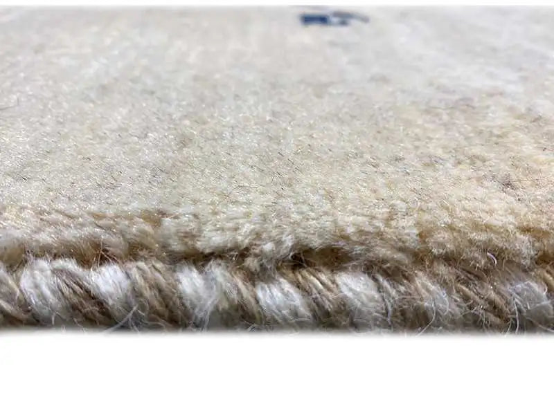 Gabbeh rug, surface detail: beige pile with a fine texture and short fibers
