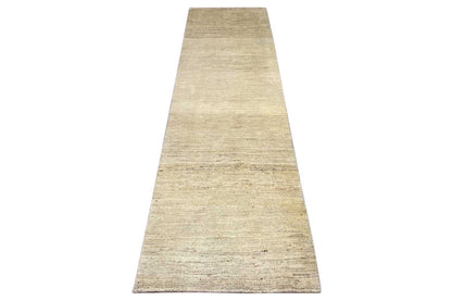 Gabbeh rug as a narrow runner in light beige, viewed from above at an angle