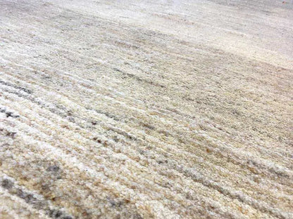 Gabbeh rug surface with a dense, mottled weave in light beige
