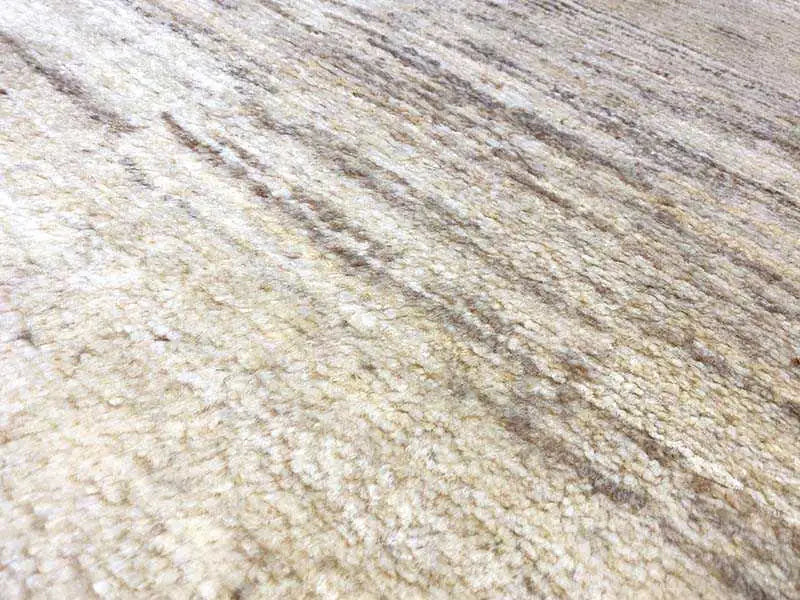 Gabbeh rug, surface in detail: beige mottled fabric with fine stripes