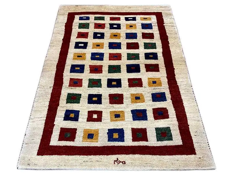 Gabbeh rug, rectangular, cream with a red border and multicolored square motifs