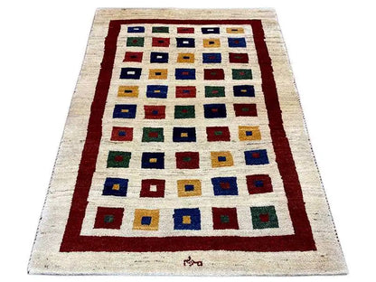 Gabbeh rug, rectangular, cream with a red border and multicolored square motifs