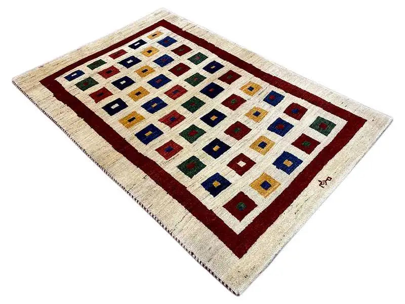 Gabbeh rug, rectangular, cream-colored with a red border, checked pattern in blue, red, and green