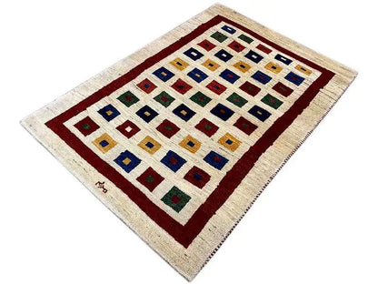 Gabbeh rug, rectangular, cream background with a red border and colorful square details