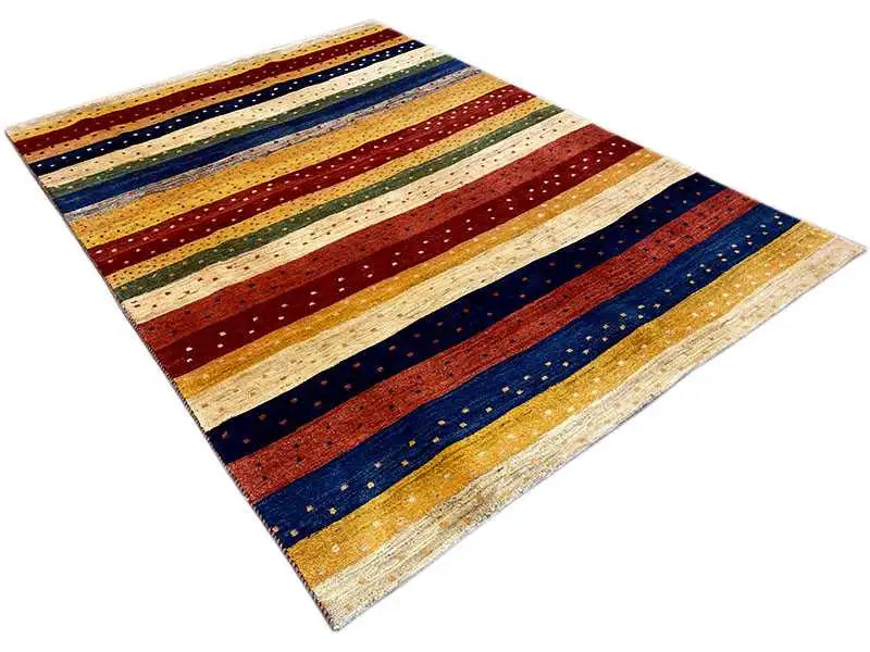 Gabbeh rug with an angled view: stripes in red, blue, cream, and gold