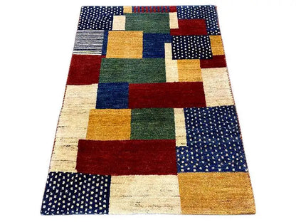 Gabbeh rug in a patchwork look with red, green, blue, and beige block patterns