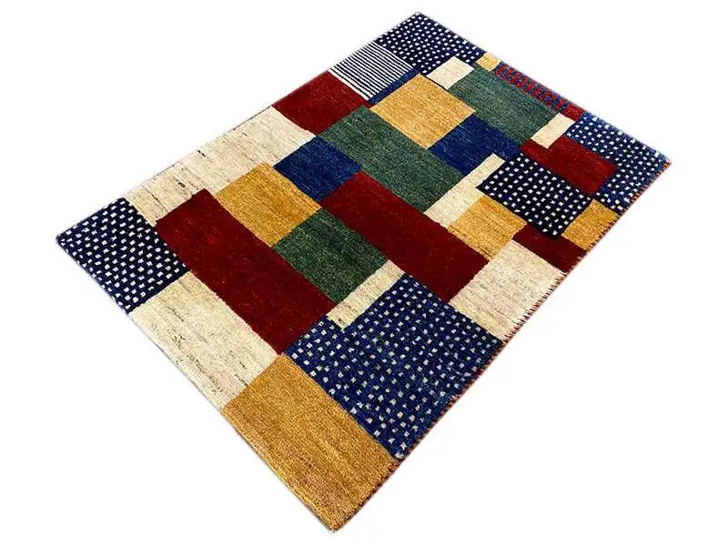 Gabbeh rug with a geometric tile pattern in dark blue, red, green, and cream
