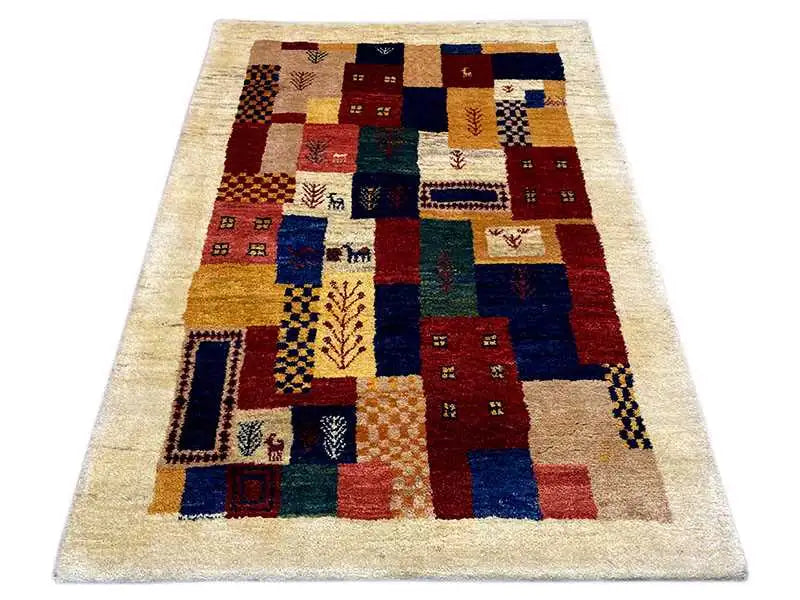 Gabbeh rug with patterned squares in blue, red, yellow, and green on a beige background