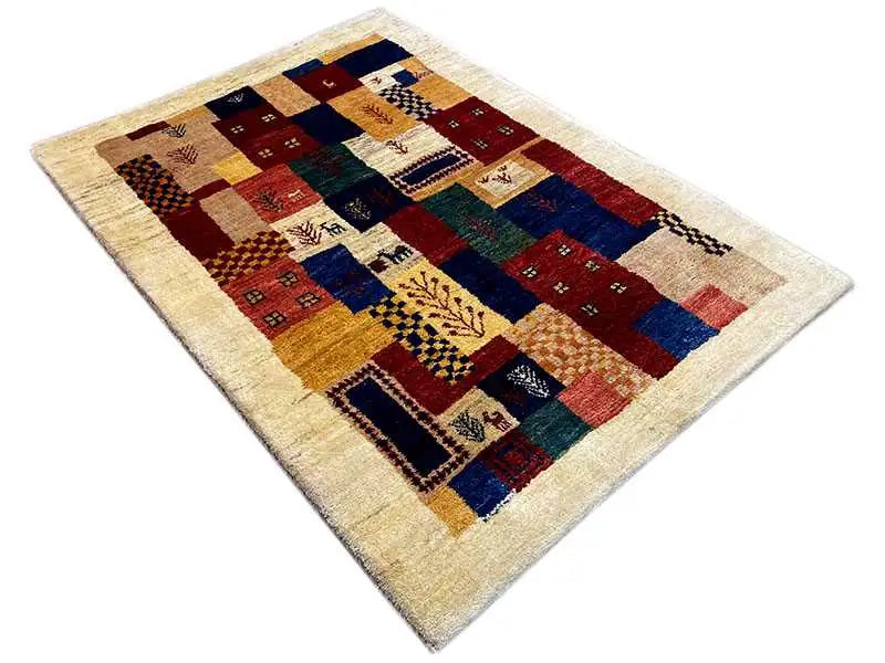 Gabbeh rug with a patchwork pattern of squares and diamonds in red, blue, yellow, and dark green
