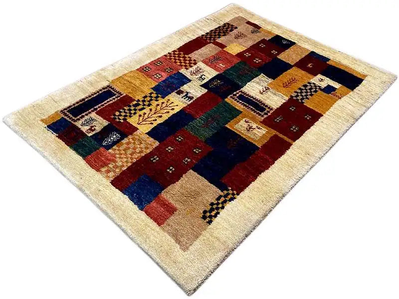 Gabbeh rug with geometric patchwork of squares in shades of red, blue, and green