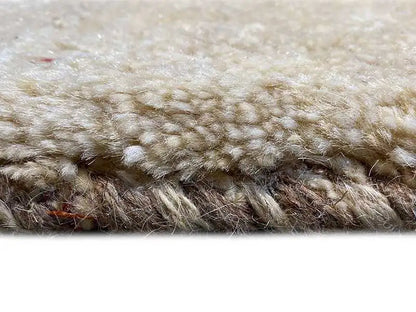Close-up of a Gabbeh rug: dense pile with a soft, beige surface
