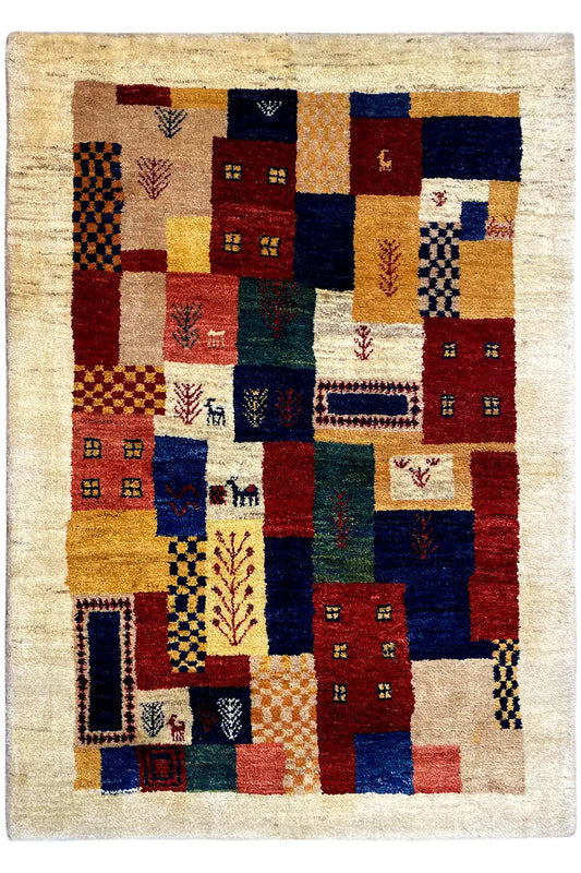 Gabbeh rug with a square patchwork pattern and bold colors on a beige background