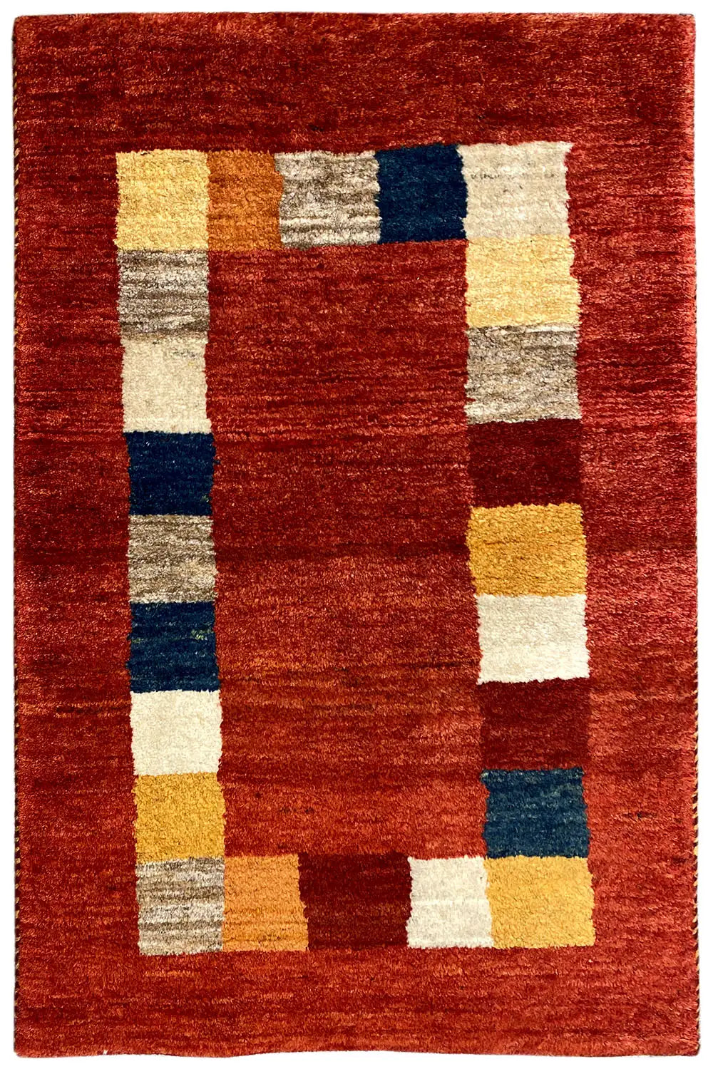 Rectangular Gabbeh rug: reddish-brown design with white, yellow, blue, and gray squares.