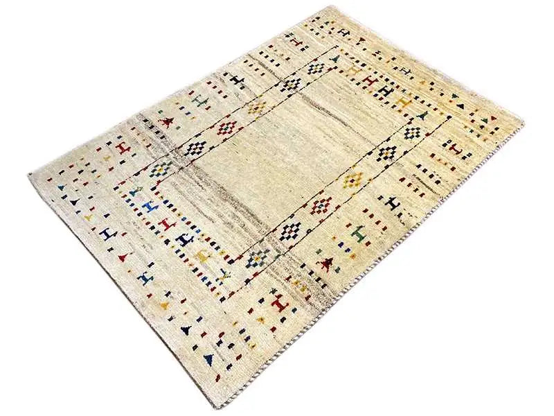 Gabbeh rug with a beige background, rectangular medallion, and ornamental border