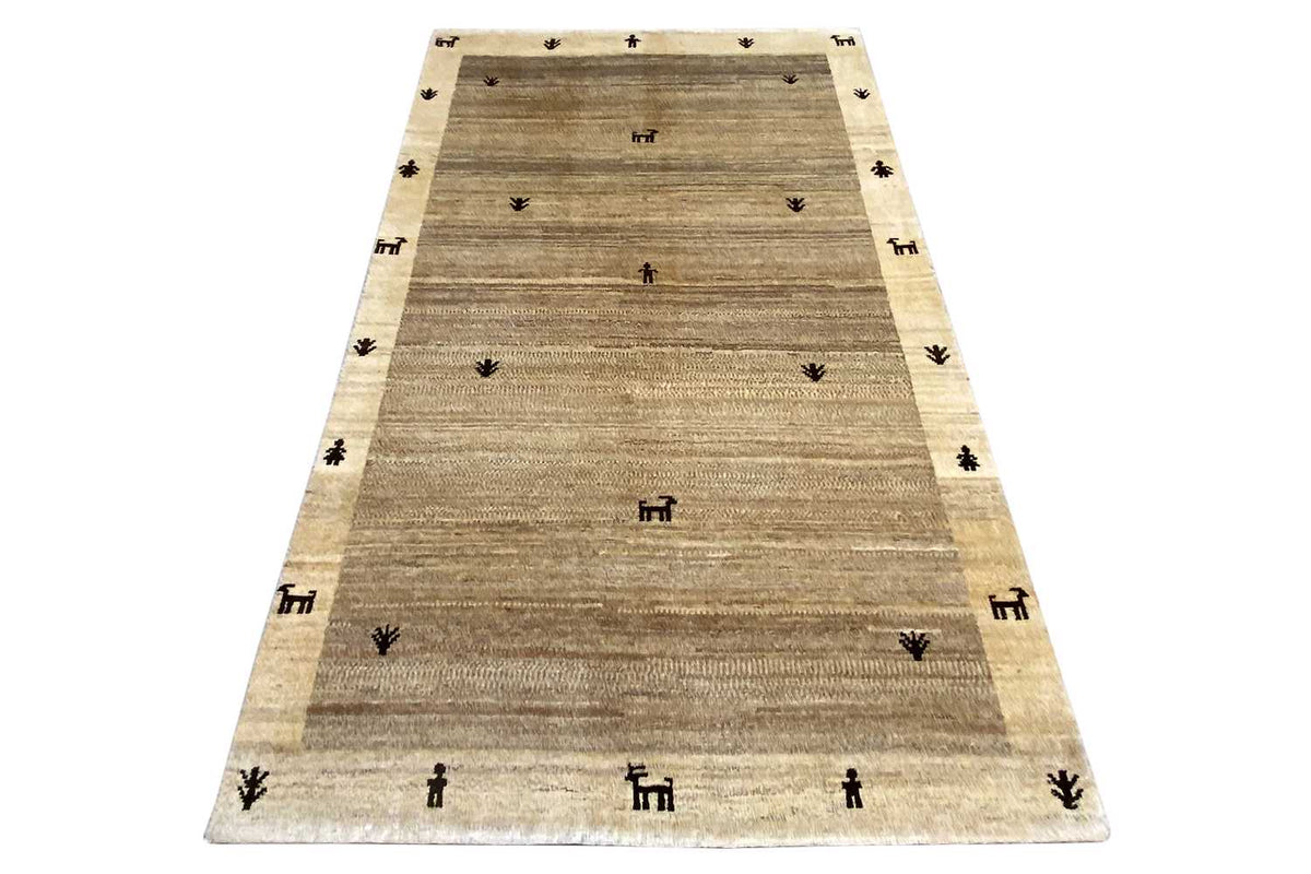 Gabbeh rug 181x116 cm, rectangular, beige with dark symbols along the edge.