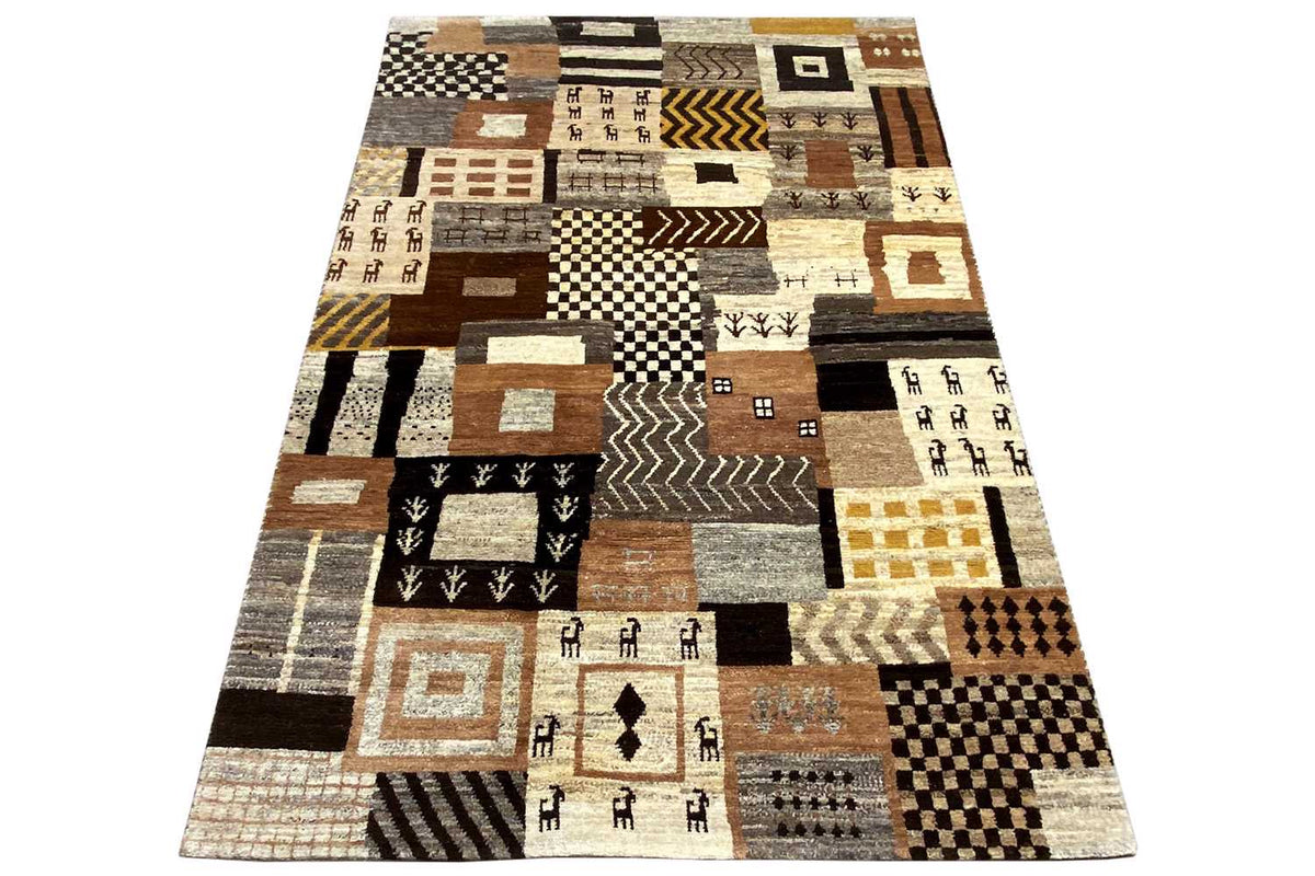 Rug with a bold geometric pattern made of patchwork blocks in beige, brown, and black